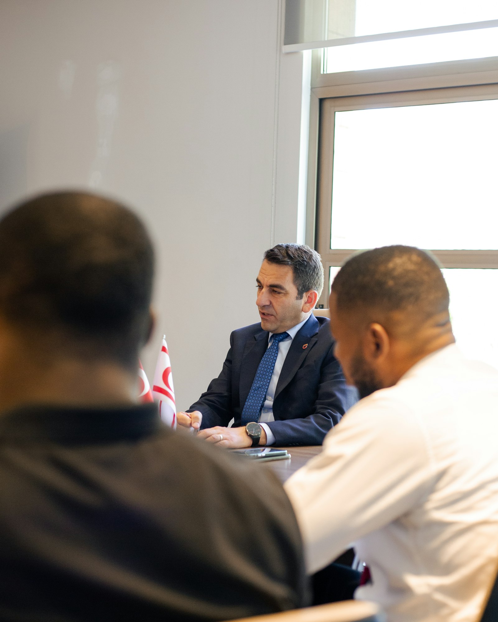 Two people in a meeting discussing a deal, the kind of conversation behind an Advisory & Deal Flow mandate.